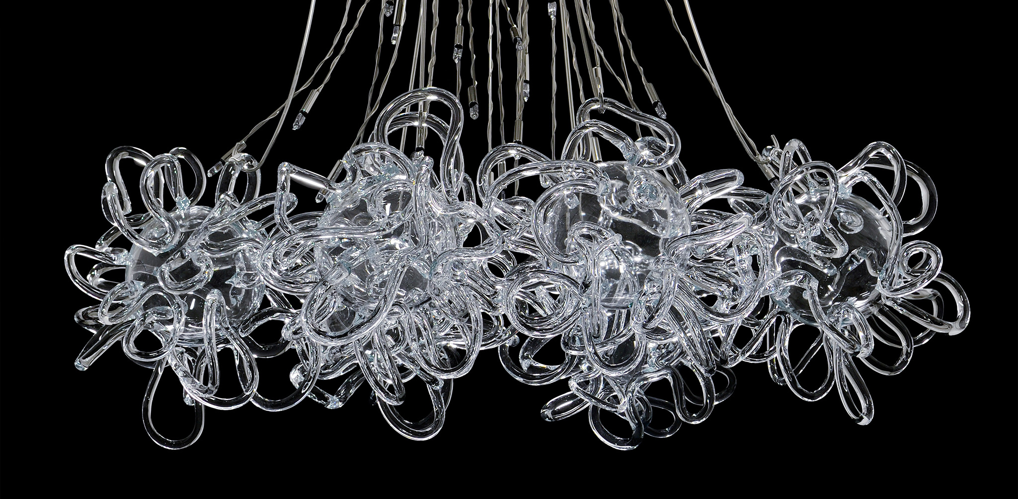 Modern glass and metal chandelier on black background